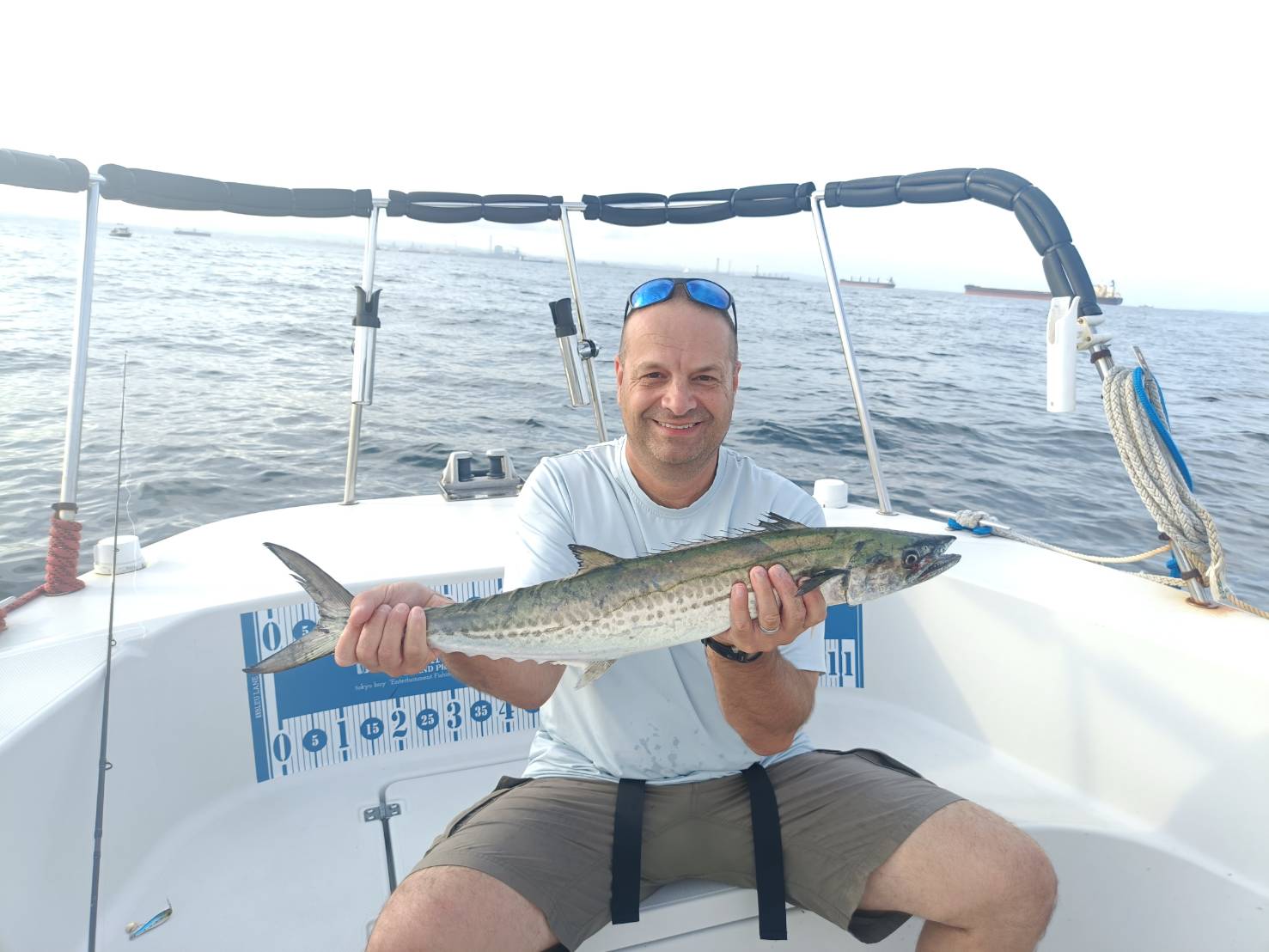 Mr. Jim holding a Spanish mackerel aboard BLEU LANE in Tokyo Bay
