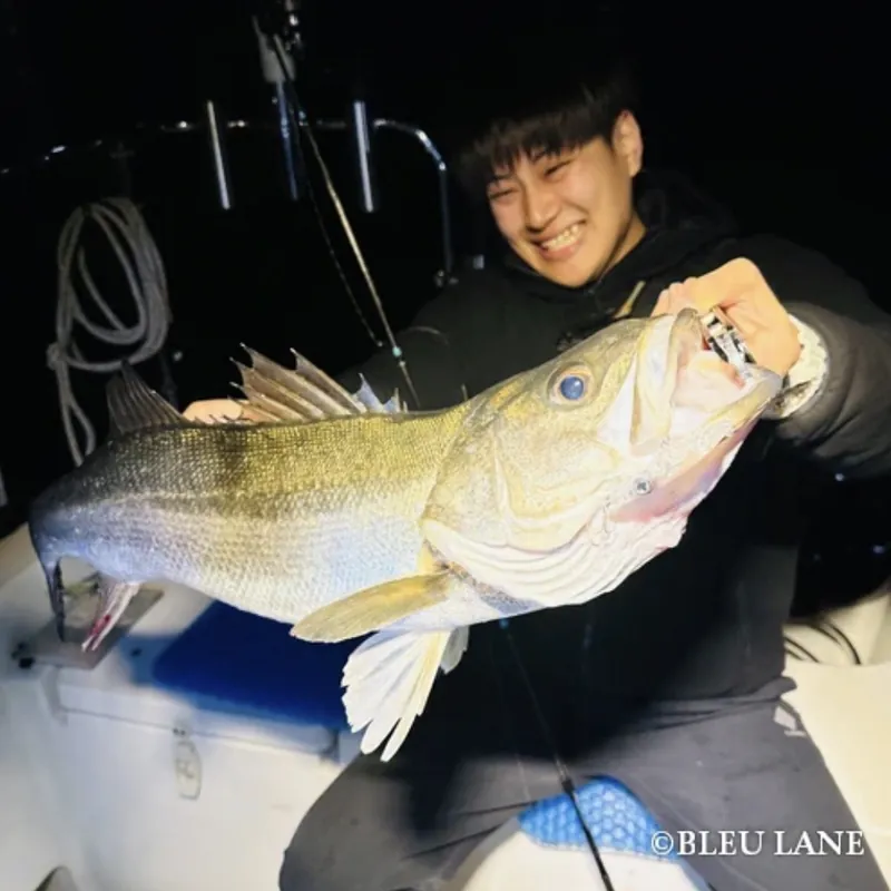 Guest with a catch during a night fishing trip