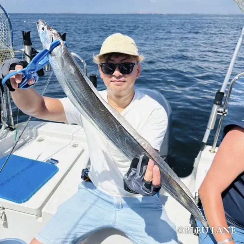 Guest holding a long silver fish
