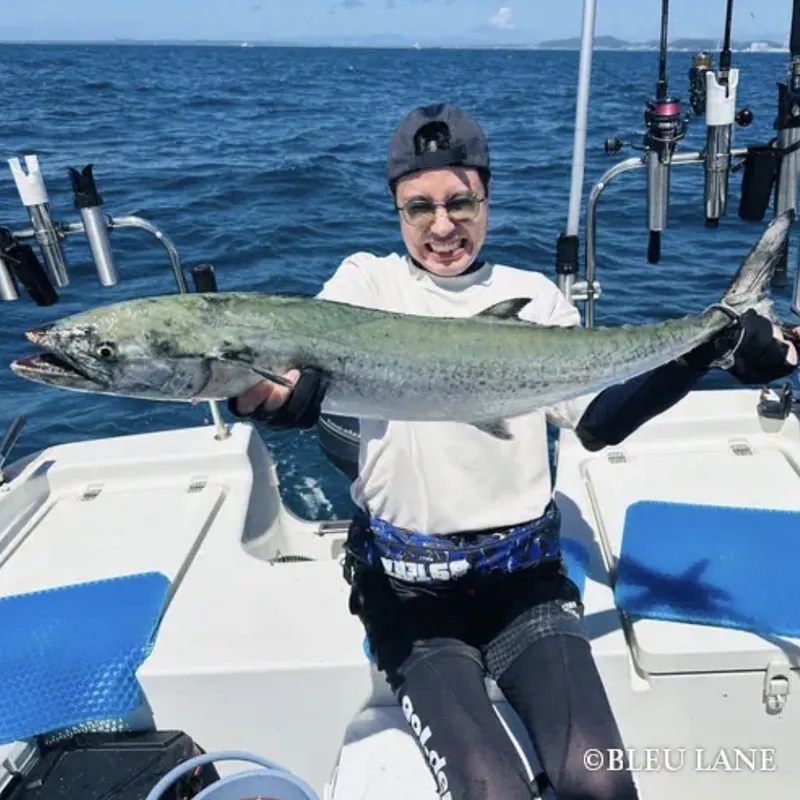 Guest holding a large fish aboard BLEU LANE