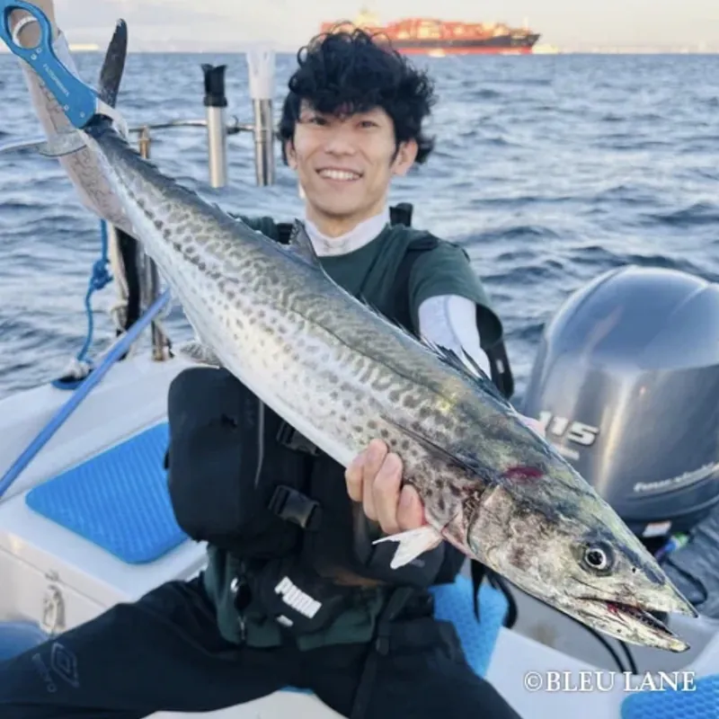 Guest holding a large fish aboard BLEU LANE
